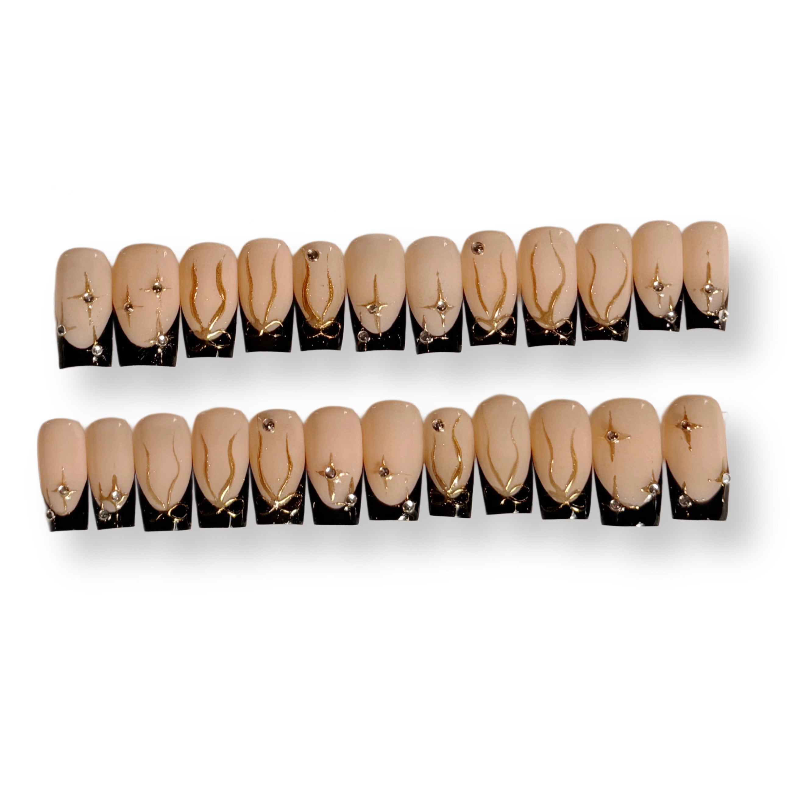 Set of 24 false nails with black tips and gold accents on a white background