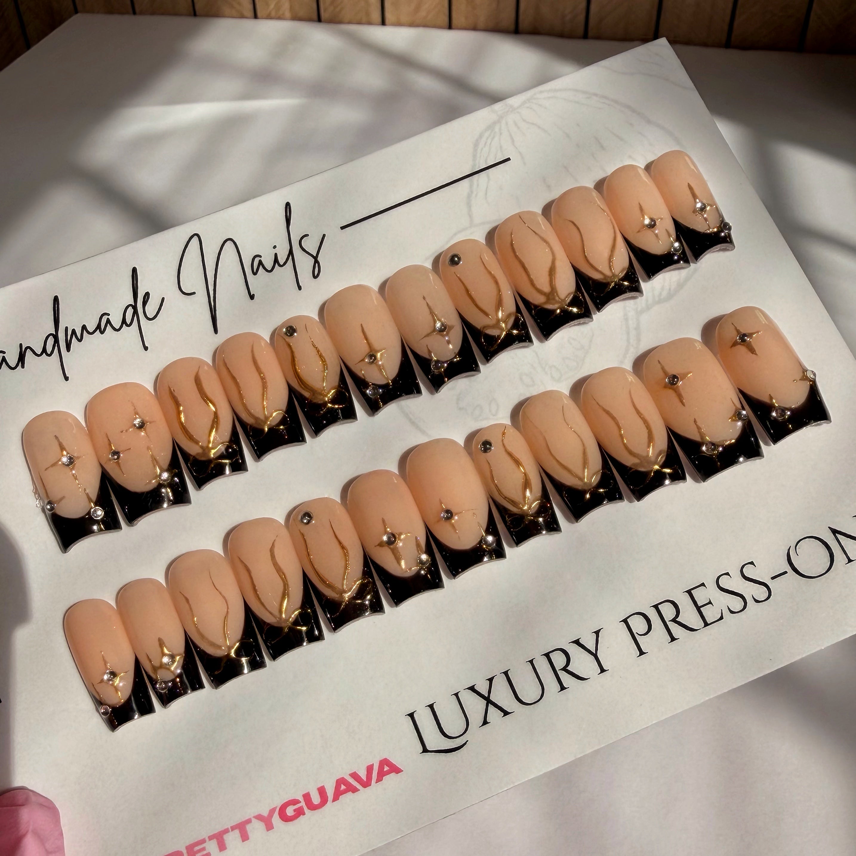 Set of press-on nails on a display card with 'PrettyGuava' branding.