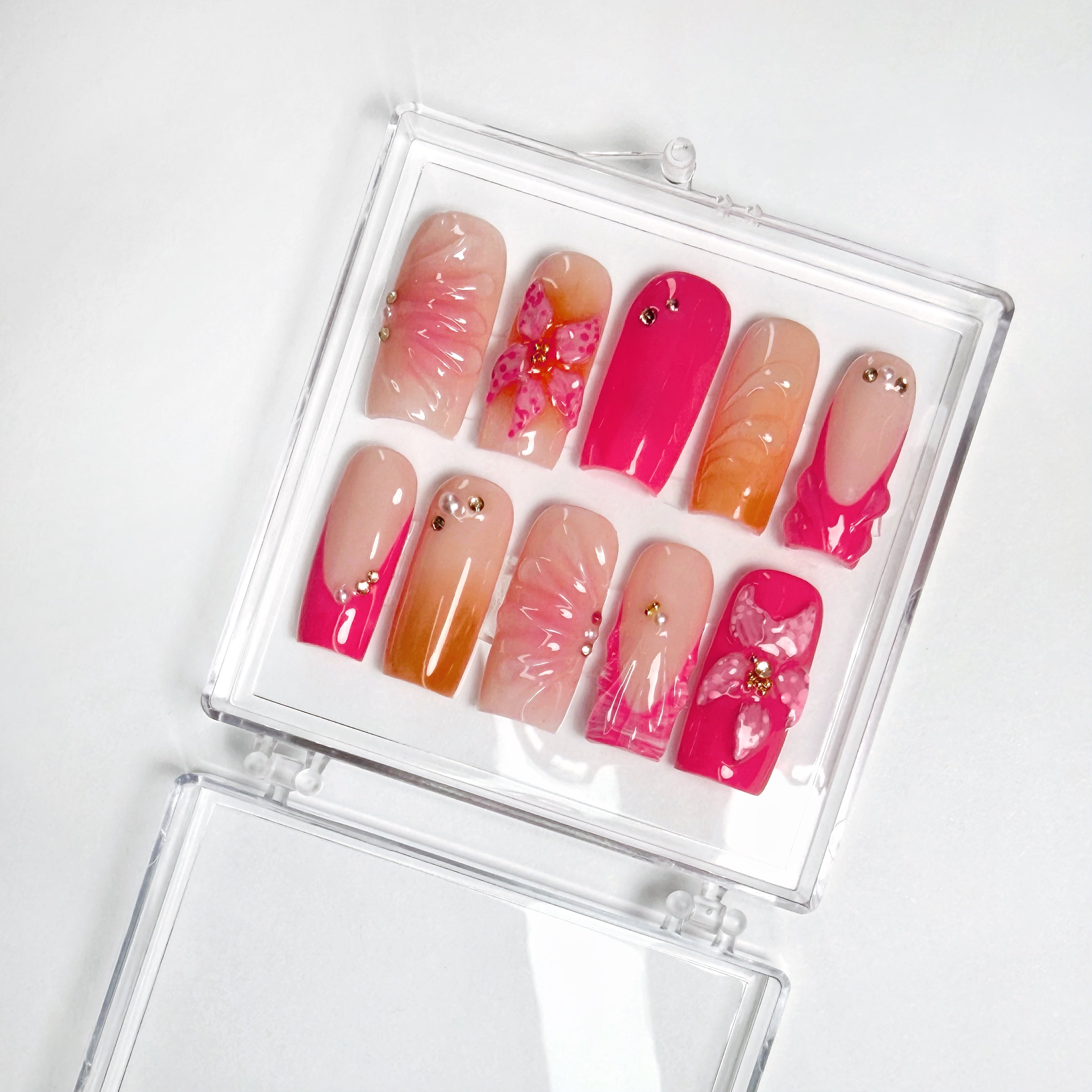 Set of pink, orange, and nude beach themed art designs in a clear case on a white background