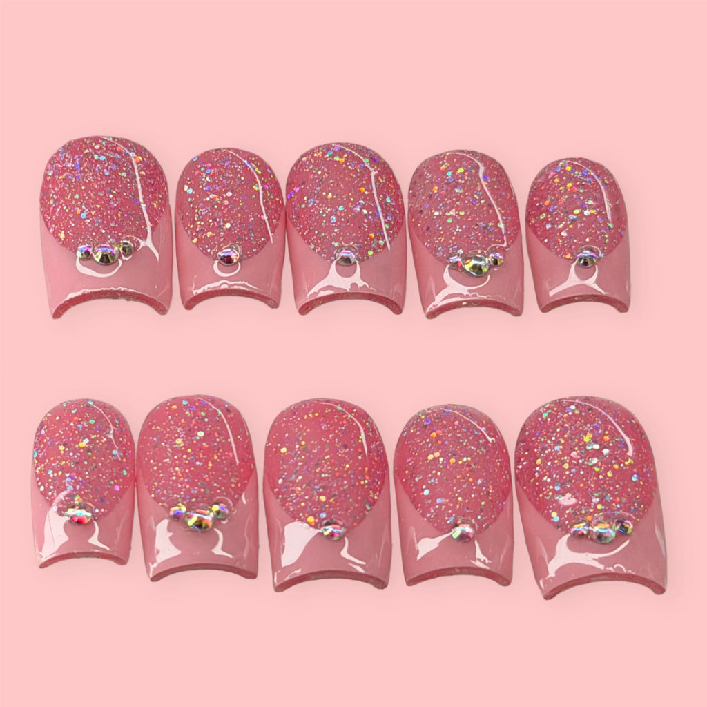 Set of pink glittery nail art designs on a pink background