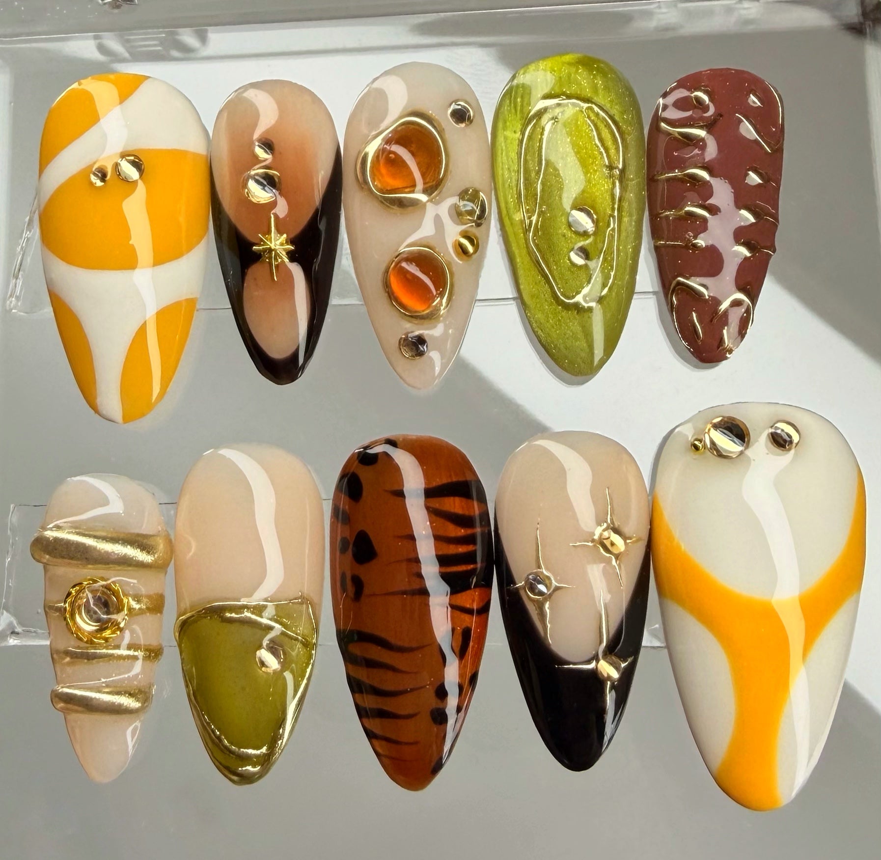 Collection of nail art designs on a clear background